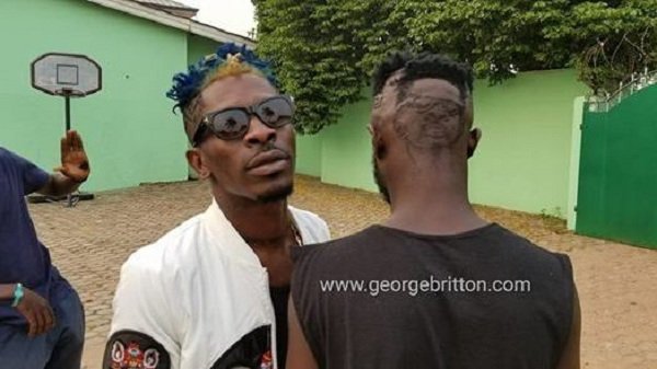 Photo: Shatta Wale Dashes GHC 500 To A Fan For Drawing His Face At His Back