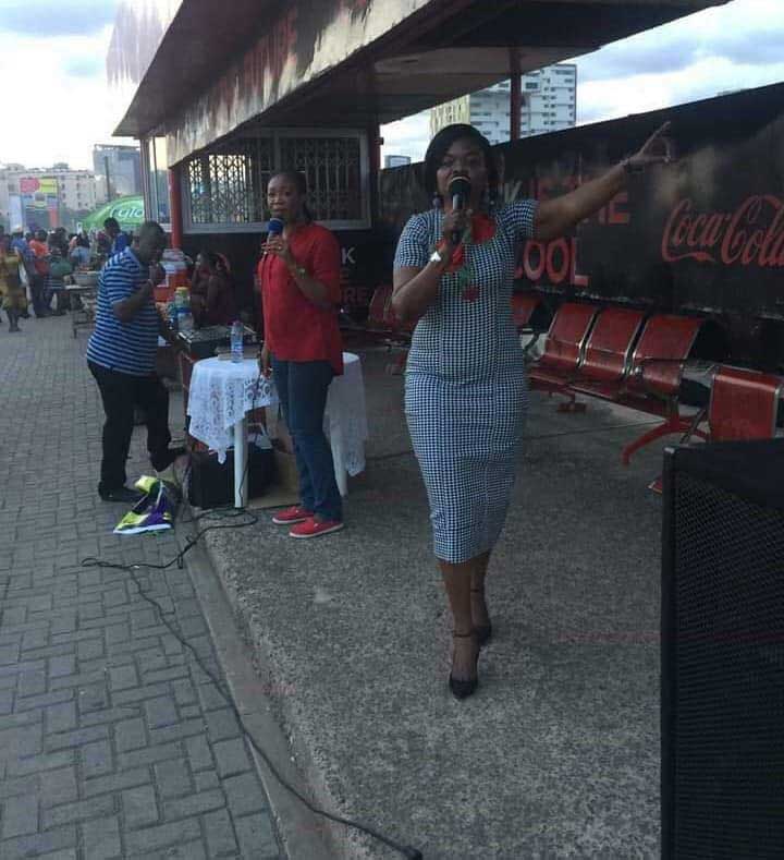 Mrs. Adwoa Asuama Abrefa preaching at a bus stop