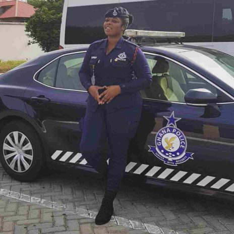 Yvonne Yaa Obrebea Appiah posing with a police car 