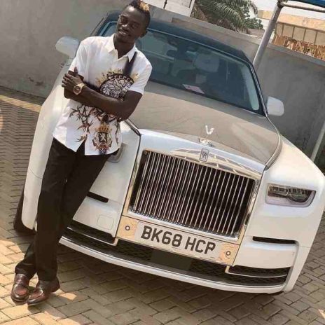 Nkansah Lilwin posing with the newly bought Rolls Royce