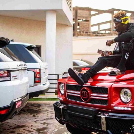 Shatta Wale posing with his cars in his house 