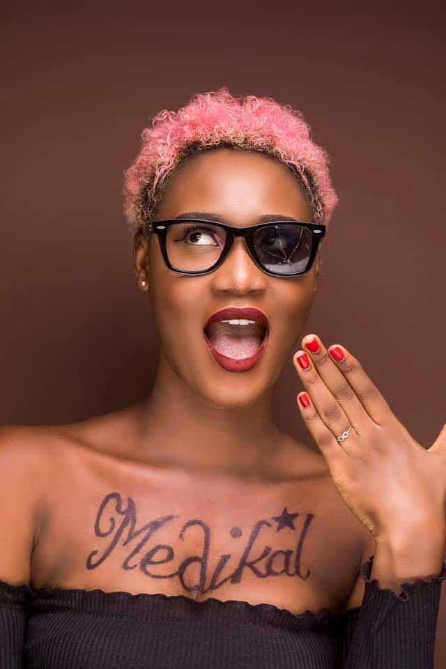 Desperate lady tattoos Medikal's name on her breast to gain his