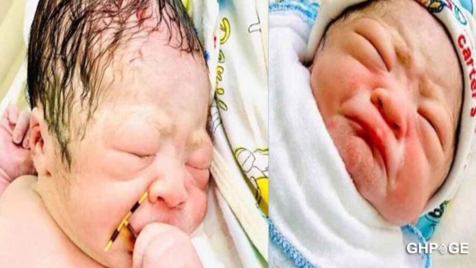 Newborn baby holds his mum’s IUD contraceptive