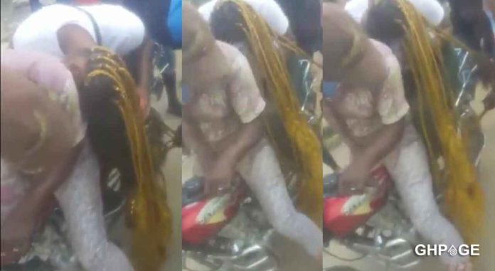 Lady-in-pain-after-her-long-hair-got-stuck-in-the-wheel-of-a-motorcycle