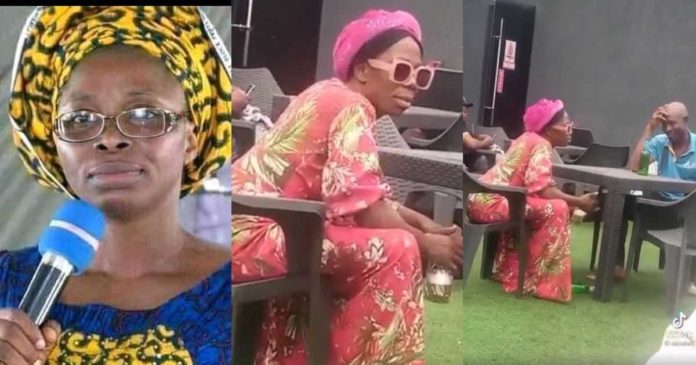 Controversial Nigerian preacher, Mummy G.O spotted drinking beer with man at spot 