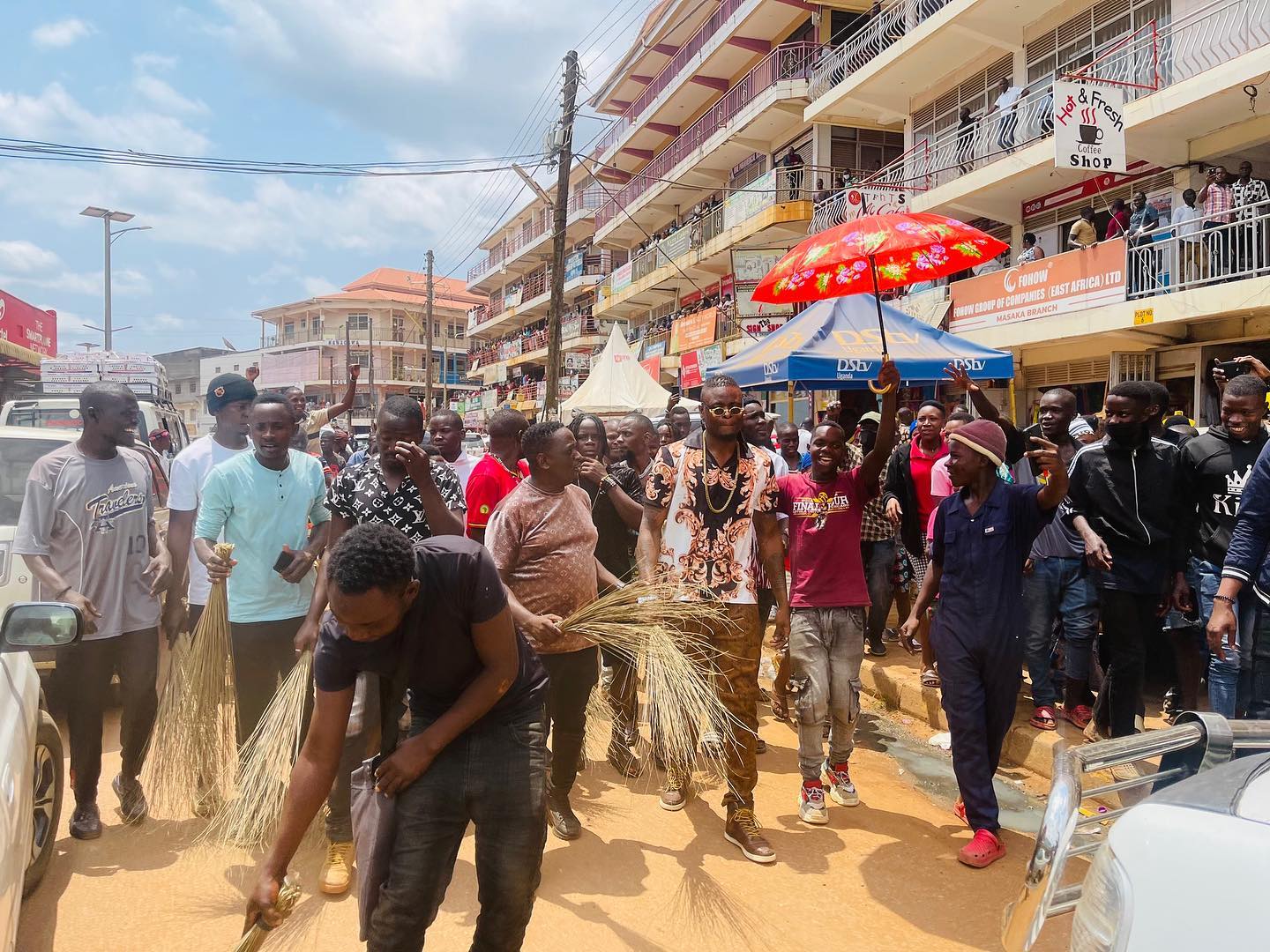 Fans force popular musician to sweep the streets after he arrived late for an event (photos)