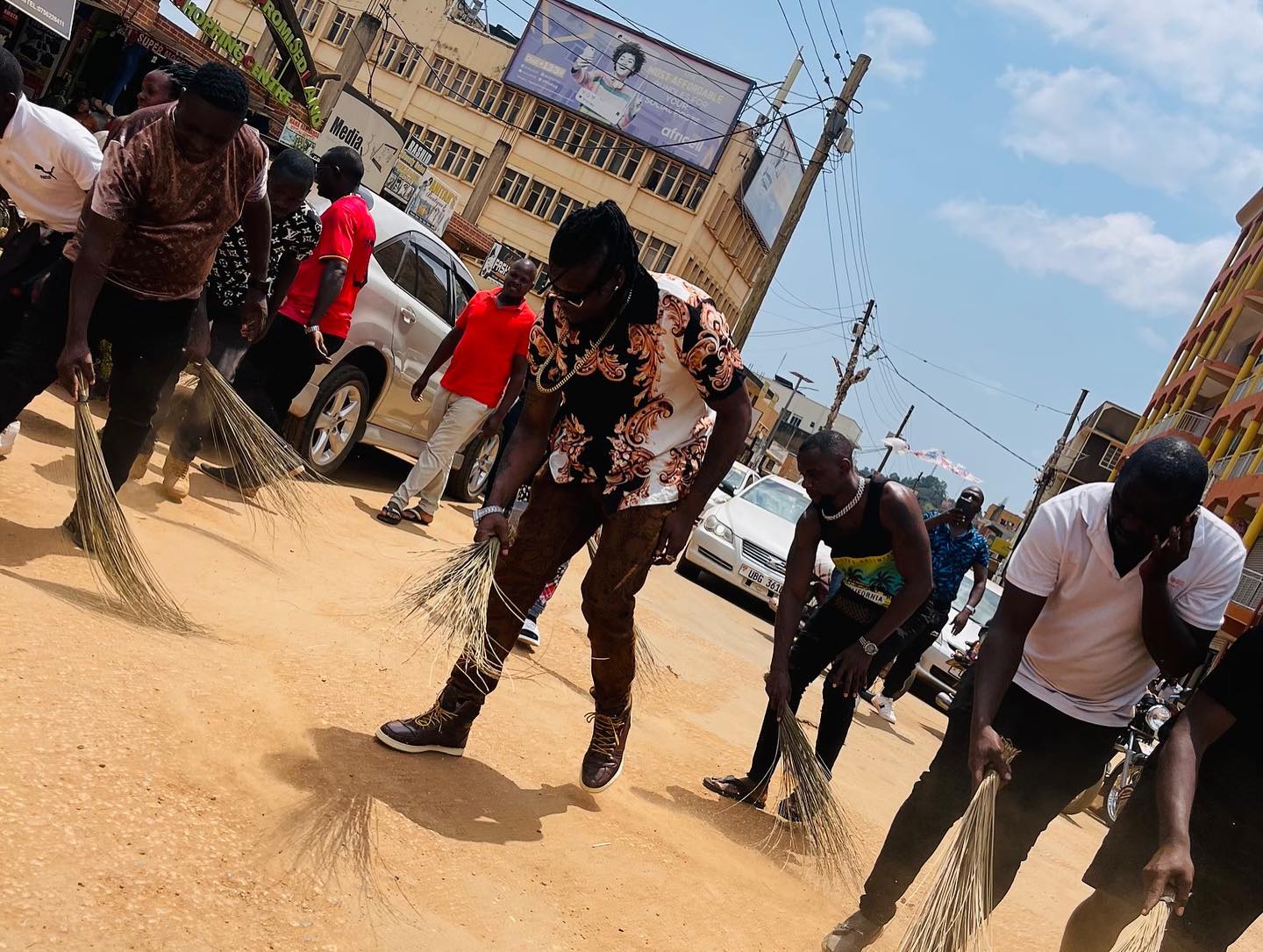 Fans force popular musician to sweep the streets after he arrived late for an event (photos)