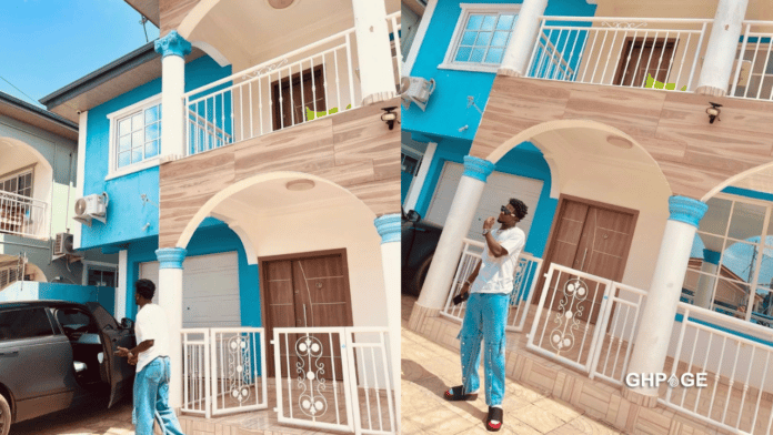 Kuami Eugene drops new stunning pictures in front of a heavy mansion