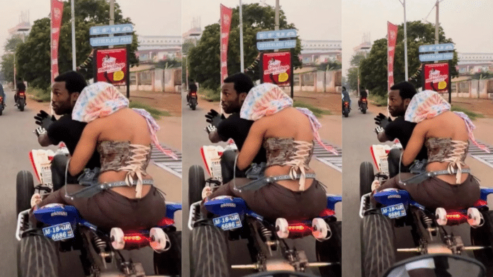 Lady hides her face from the camera while riding with Meek Mill in Accra