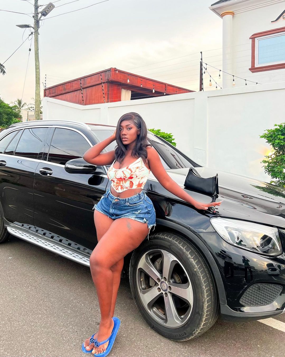 Hajia Bintu poses with her Mercedes Benz