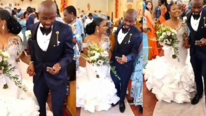 Groom ignores his bride to concentrate on his phone during their wedding