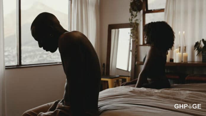 Couple sitting on a bed together