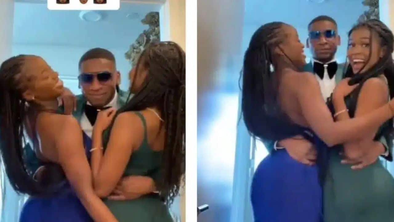 Young man happily shows off his two girlfriends