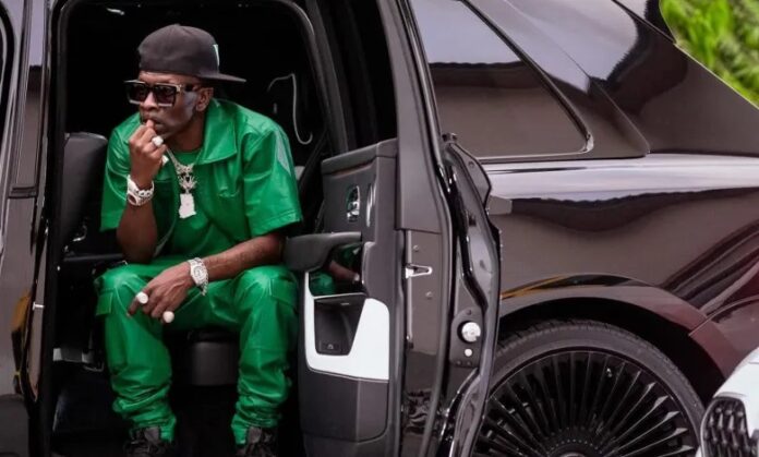 Shatta Wale sits in his Rolls Royce